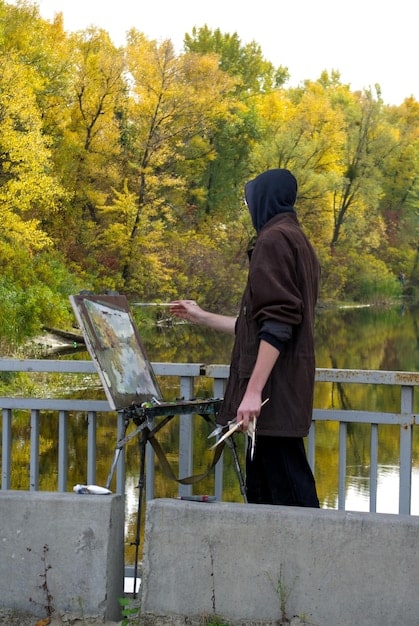 A behind-the-scenes image of a Wild Rift content creator setting up their streaming equipment, accompanied by text highlighting tips and tricks for creating engaging content, such as using high-quality audio and video, and interacting with viewers.