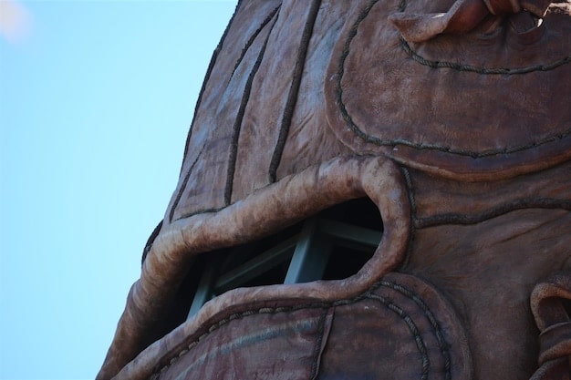 A close-up shot of a cosplayer's meticulously crafted weapon prop, inspired by Vi from Wild Rift. The prop is highly detailed, with visible craftsmanship.