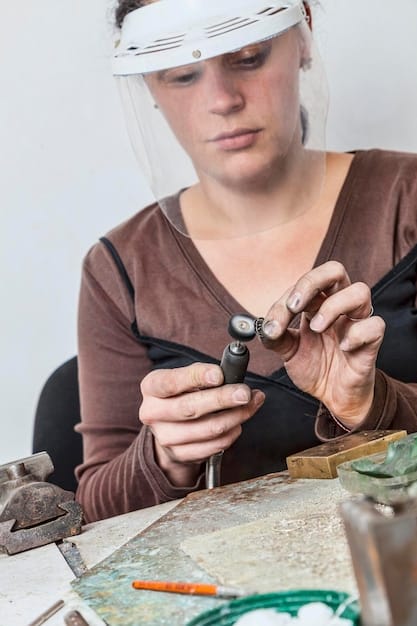 A cosplayer working on a helmet for a Wild Rift character. The workshop setting includes various tools, paints, and materials.
