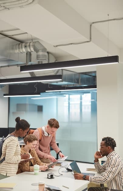 A brightly lit, modern co-working space buzzing with activity, focusing on diverse individuals collaborating on laptops and whiteboards, subtly showcasing technology and teamwork in action.