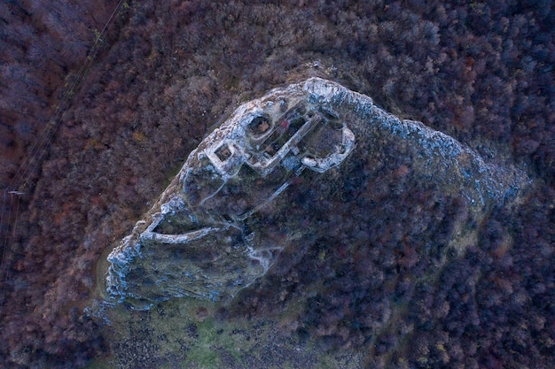A drone flying high above a remote, winding river that forms a natural border, with advanced sensor imagery overlayed on the scene, depicting the future of autonomous surveillance.