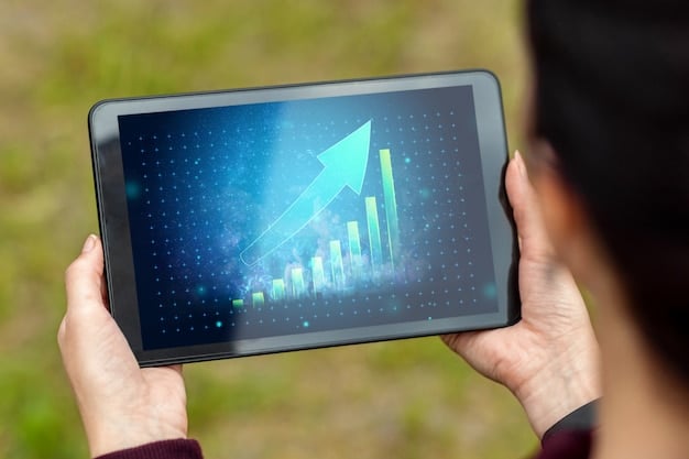 A close-up of a hand pointing at a line graph on a tablet, showing a downward trend in interest rates, with financial data in the background.