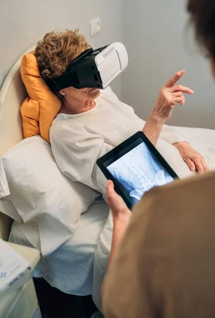 A child with a VR headset lying in a hospital bed, looking calm while a nurse tends to their arm, illustrating non-pharmacological pain relief methods.