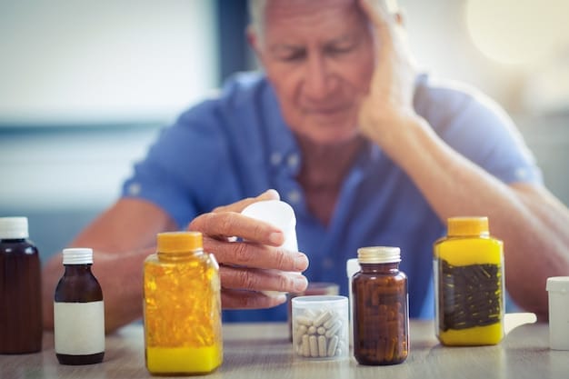 A person looking stressed and clutching their head, with healthcare bills and prescription bottles scattered around them on a table.