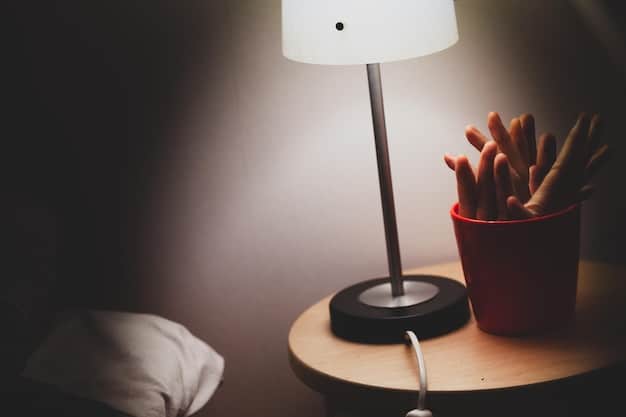 A close-up shot of a modern, sleek light therapy lamp on a desk, emitting a bright white light, with a comfortable office chair in the background, suggesting ease of use in a daily routine.