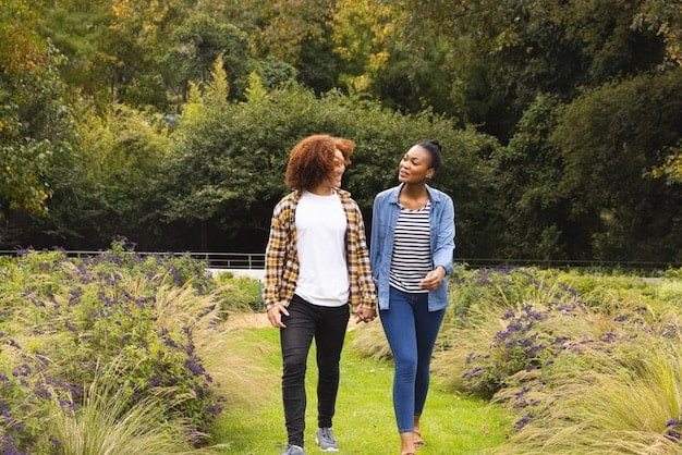Two friends enjoying a walk in a park, symbolizing the ongoing nurturing of supportive relationships and maintaining mental wellness.