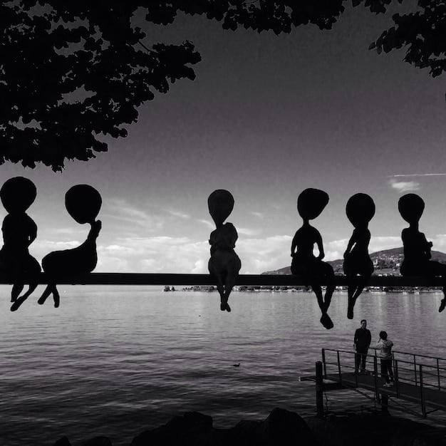 A silhouette of a lonely figure standing apart from a lively, laughing group of friends, illustrating feelings of isolation in a social setting.